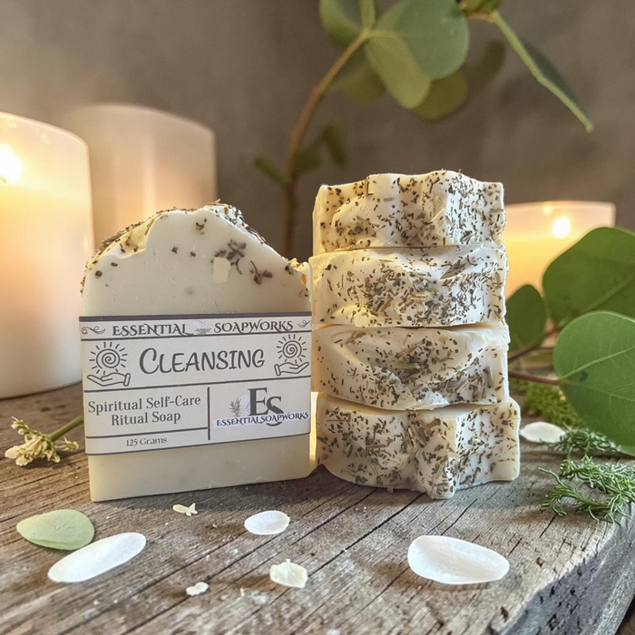 energy cleansing soap bars on a wooden surface with greenery and candles in the background