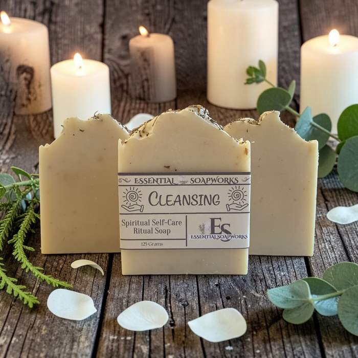 energy cleansing soap bars on a wooden surface with greenery and candles in the background