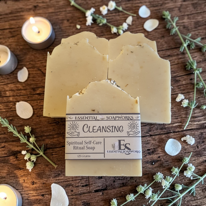 energy cleansing soap bars on a wooden surface with greenery and candles in the background
