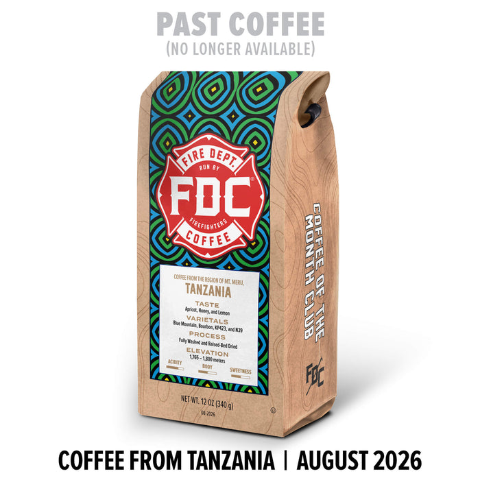 A bag of FDC Coffee from Tanzania stands upright on a white background. The package has a natural wood-toned side and a colorful geometric label in green, blue, and red.