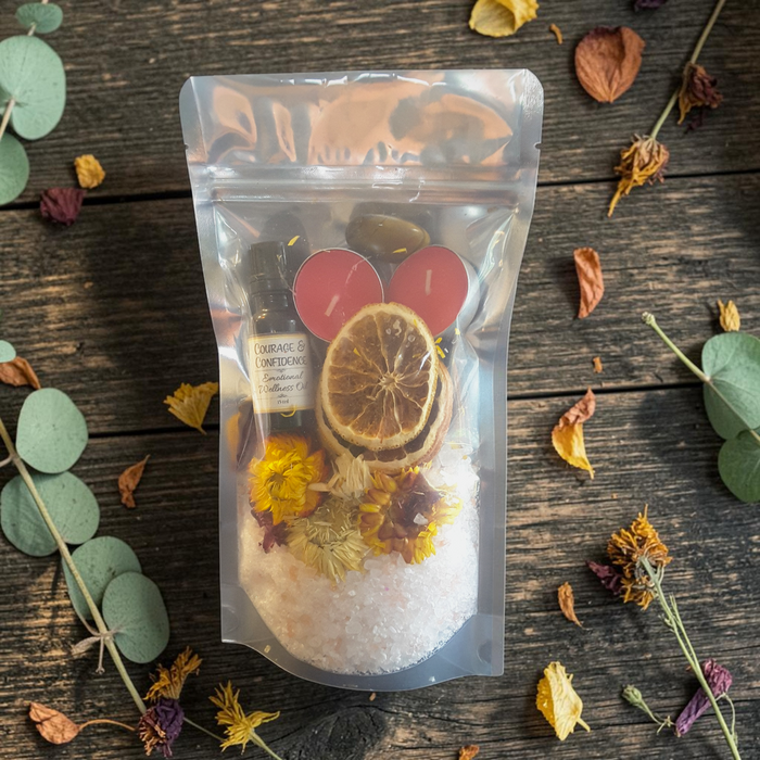 Confidence & Vitality Bath Ritual Kit with tealight candles, flowers, orange slices, tiger's eye crystal and ritual oil on a wooden surface