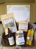 Courage & Confidence Emotional Balance Ritual Kit including a tea blend, essential oil bottle, soap, and candles.