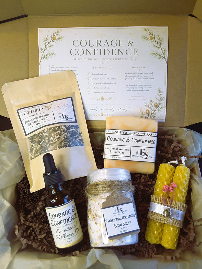 Courage & Confidence Emotional Balance Ritual Kit including a tea blend, essential oil bottle, soap, and candles.