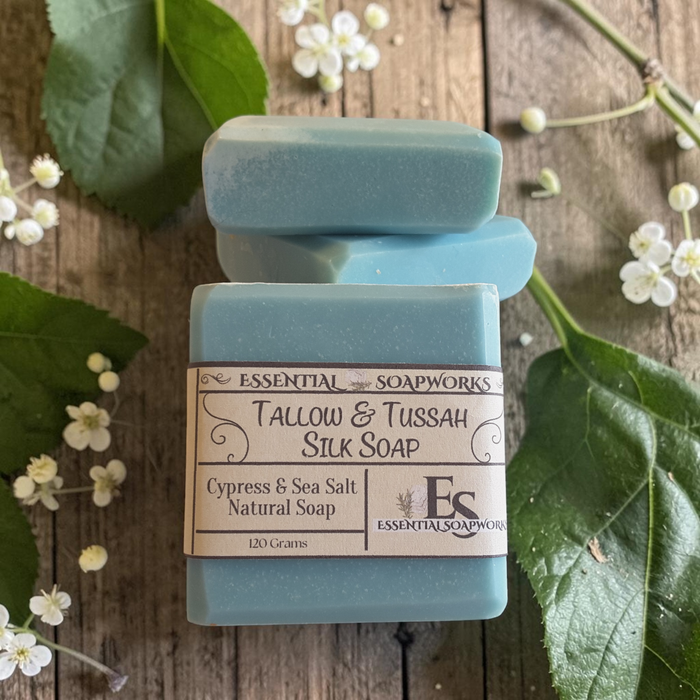 cypress tallow soap on a wooden surface with white flowers