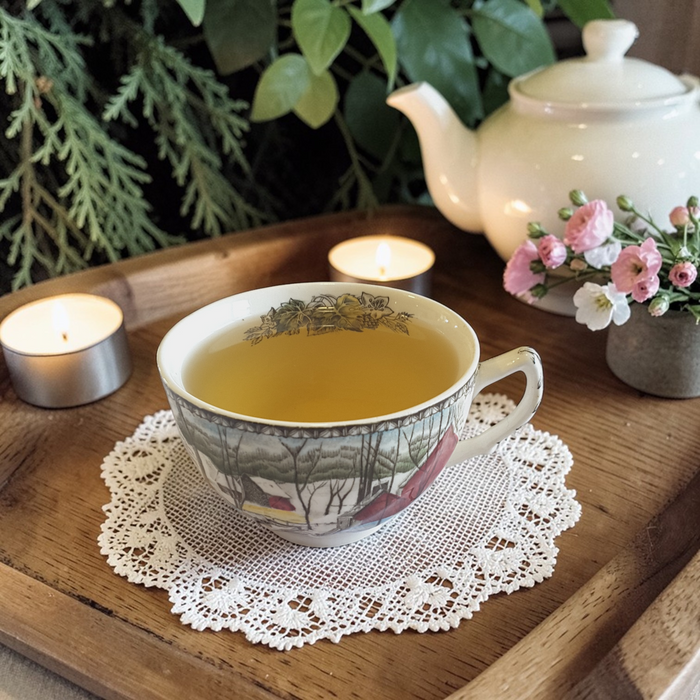 deep sleep tea on a doily with a teapot and flowers in the background