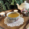 deep sleep tea on a doily with a teapot and flowers in the background