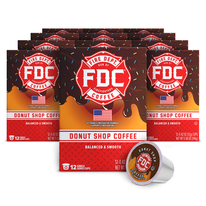 Multiple boxes of FDC Donut Shop Coffee with a single cup on a white background