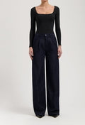 Model wearing Carry Mid Straight jeans in black vintage, made from sustainable organic and recycled cotton, offering a straight fit.