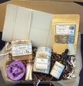 Evening Wind Down Ritual Kit featuring soap, tea, candle, essential oil blend, journal and bath salts