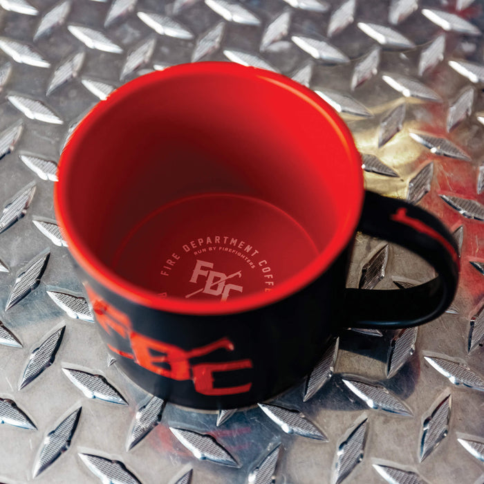 Top view of the red inside of black FDC pike pole mug, revealing a white FDC pike pole logo at the bottom of the mug