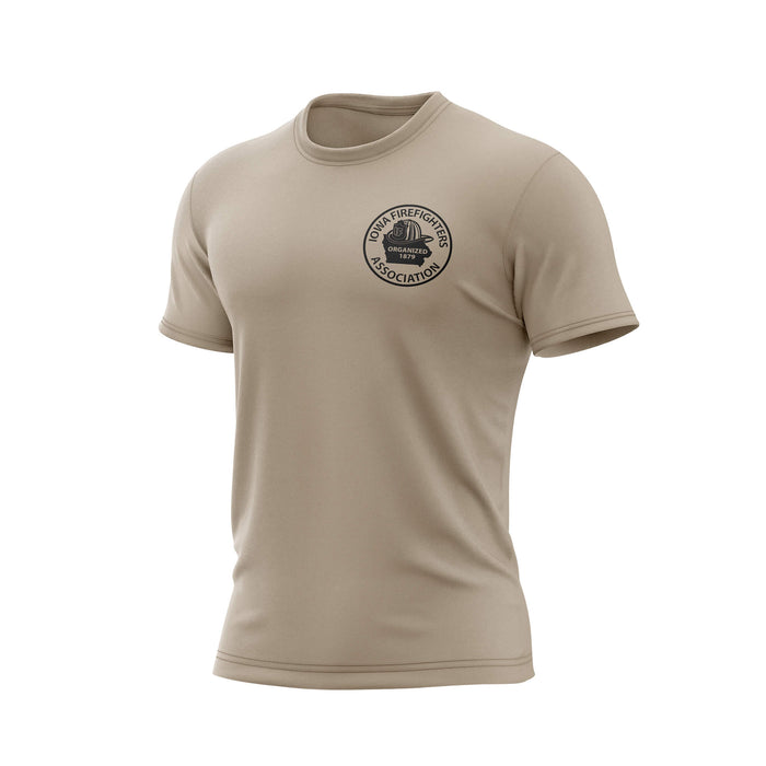 A beige short-sleeve crewneck t-shirt with a circular black graphic on the left chest reading 'WORLD TRAFFICKER ASSOCIATION' around a central emblem, shown on a plain white background.