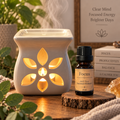 Focus essential oil diffuser blend alongside an essential oil burner on a wooden surface
