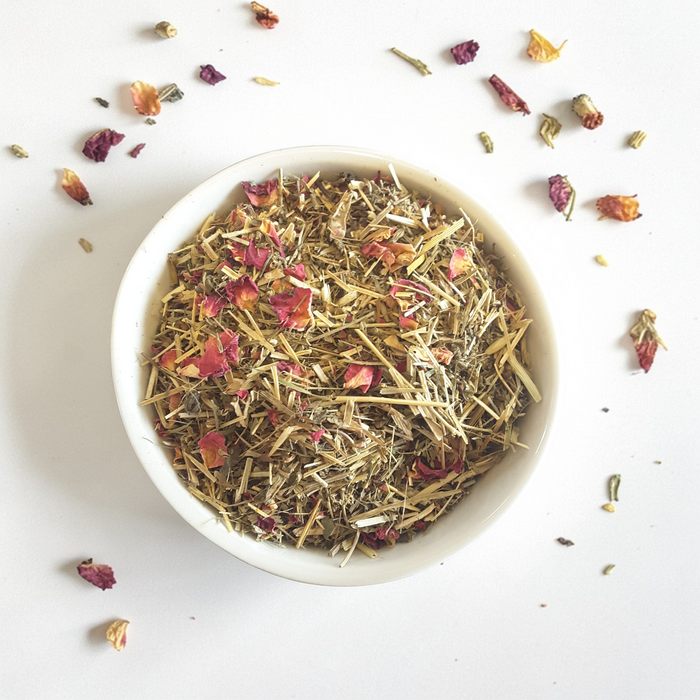 White bowl filled with loose leaf Gentle Surrender tea on a white background
