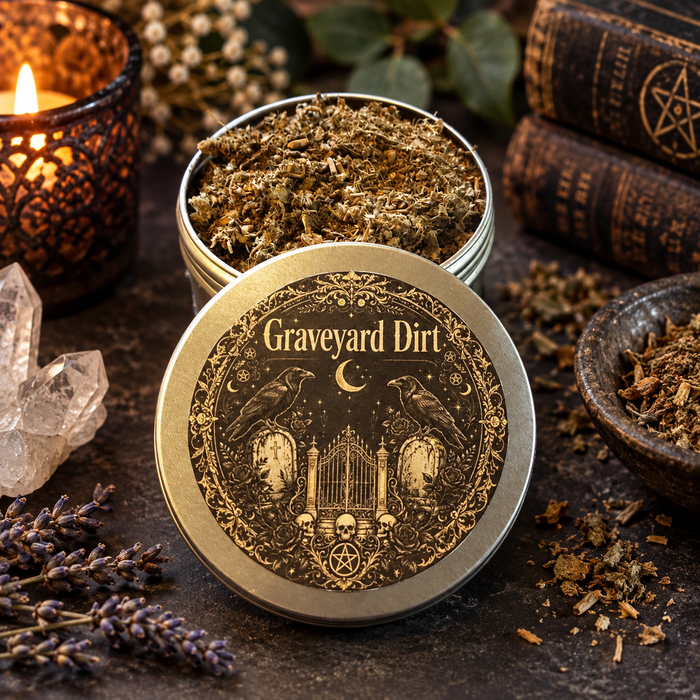 graveyard dirt on a dark surface with botanicals, crystals and candles