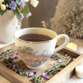 Grounding tea blend on a wooden tray with herbs and candles