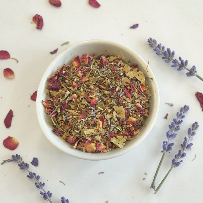 Loose leaf emotional wellness tea on a light surface with lavender sprigs.
