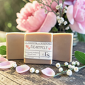 Heartfelt Emotional Wellness Soap on a wooden surface with pink flowers in the background