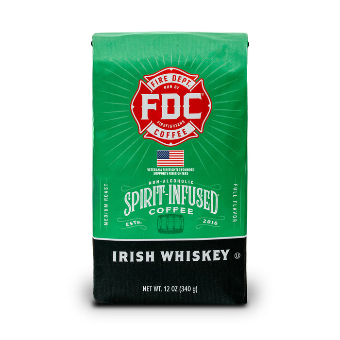 A 12 oz bag of FDC Spirit Infused Coffee in the Irish Whiskey flavor. The packaging features a bright green top half with a red FDC logo, and a black bottom half with white text.