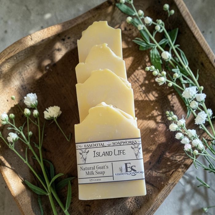 goat milk soap bars on a wooden tray with flowers