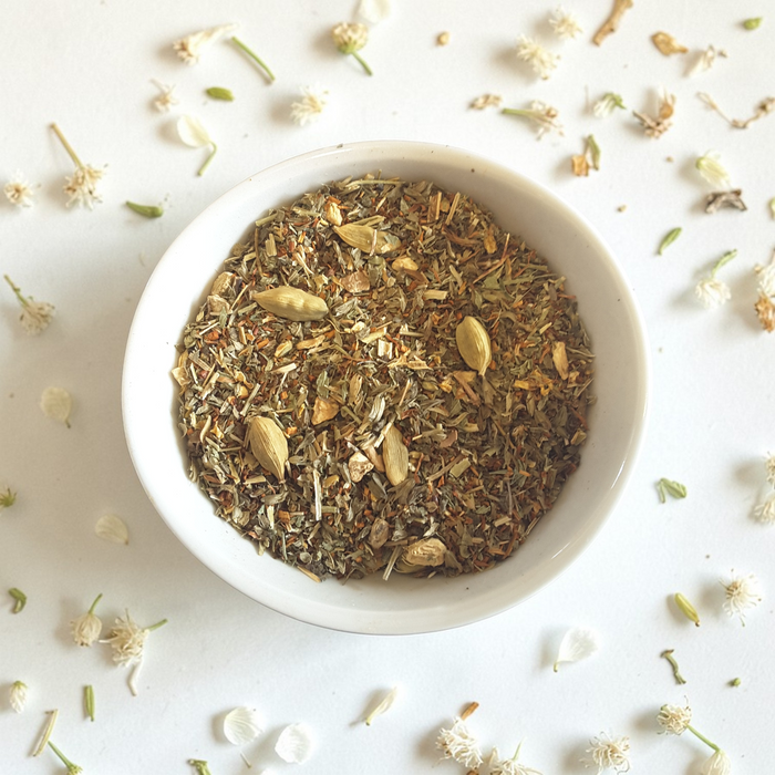 Joy loose leaf wellness tea on a light background with scattered flowers