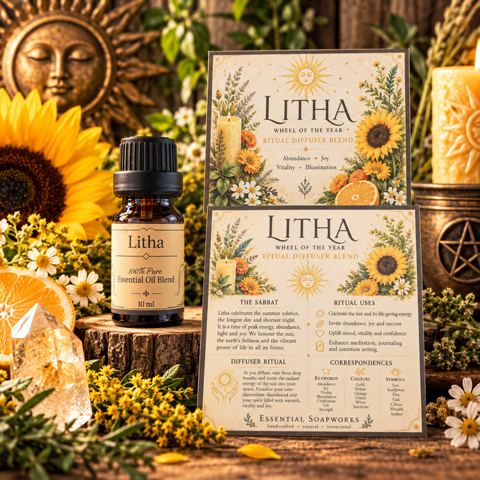 A 10 ml amber glass bottle of Litha Pure Essential Oil Blend stands next to two printed cards for the 'Wheel of the Year' ritual diffuser blend by Essential Soapworks. The scene is styled with sunflowers, yellow wildflowers, a bronze sun face, and a brass candle holder against a warm, rustic background.