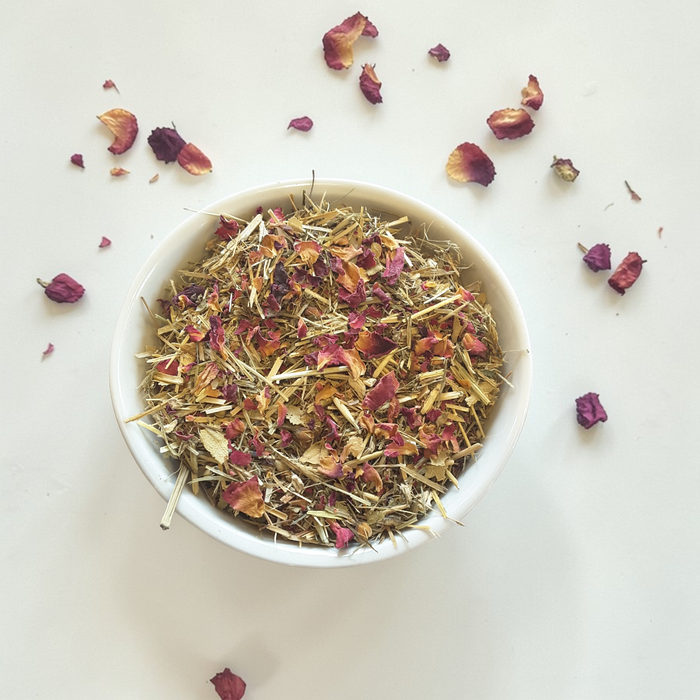 Love & Compassion emotional wellness tea in a white bowl on a light background