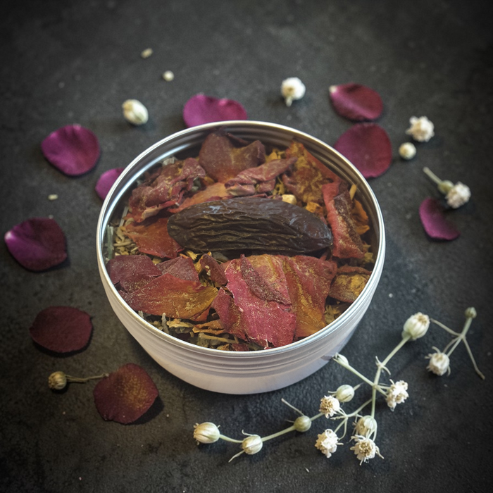 Love Spell loose incense on a dark surface with petals and flowers around