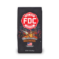 A bag of Fire Department Coffee's 12 oz Marshmallow Brownie Coffee with a red section accross the top that says "Fire Dept. Coffee". The art on the bag features a beaver holding a pike pole with a marshmallow and brownie on it over a campfire. The title reads, "Marshmallow Brownie" and there is a veteran owned badge with an American flag in the bottom right corner.
