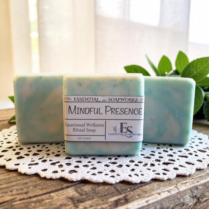 Mindful Presence Emotional Wellness Soap on a doily with plants in the background.
