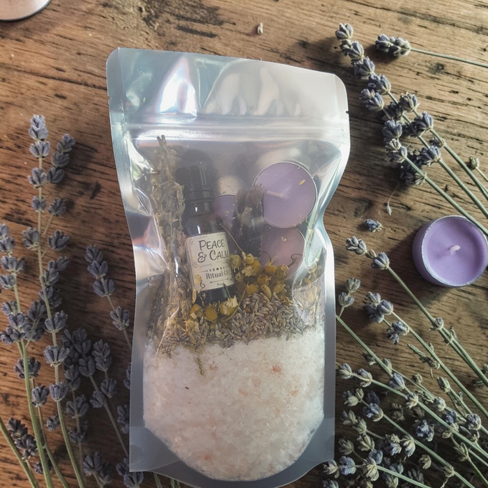 Peace & Calm Bath Ritual Kit with lavender, chamomile, tealight candles, ritual oil and amethyst crystal on a wooden background