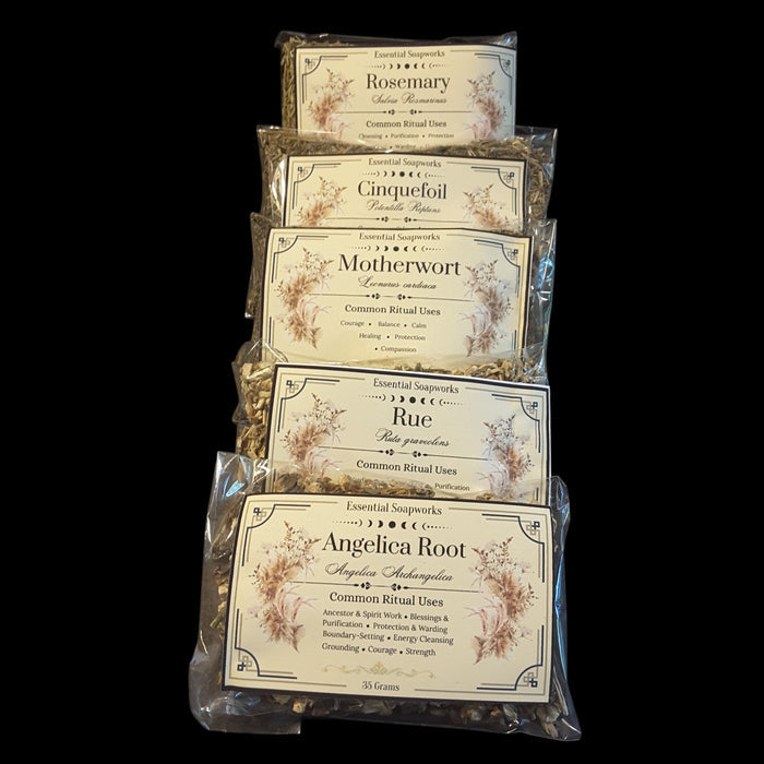 Five clear plastic bags of dried botanical blends stacked vertically against a solid black background. The labels read Rosemary, Cinquefoil, Motherwort, Rue, and Angelica Root, with decorative beige labels and visible dried herbs inside.