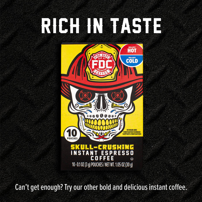 A boxed coffee pouch package centered on a black textured background with large white text reading 'RICH IN TASTE' above and a tagline below. The package is bright yellow and black with a skull wearing a red firefighter helmet and a red badge that says 'FDC'.