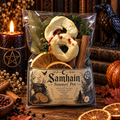 samhain simmer pot blend featuring cedar, rosemary, orange slices, apple slices and cinnamon sticks and bay leaves on a dark wooden surface