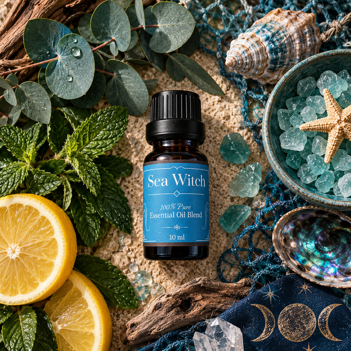 Sea Witch diffuser blend on a sandy surface surrounded by lemon slices, eucalyptus, mint leaves and blue crystals