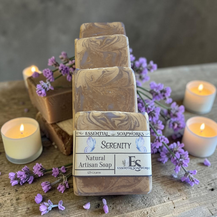 vanilla lavender serenity soap on a doily with purple flowers and candles in the background