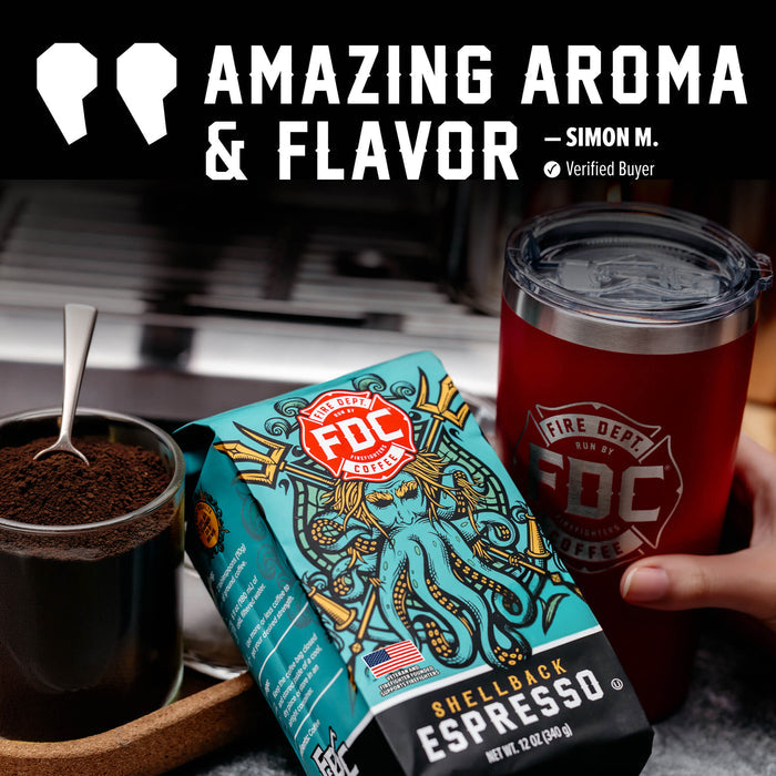 A hand holds a red insulated tumbler next to a bag of FDC Fire Department certified espresso, with ground coffee and a spoon in a glass in the foreground. Large text at the top reads 'AMAZING AROMA & FLAVOR - SIMON M.