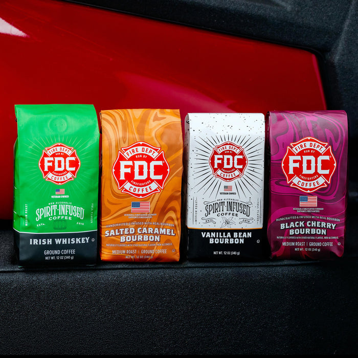 Four packages of FDC Coffee with different flavors on a red and black background.