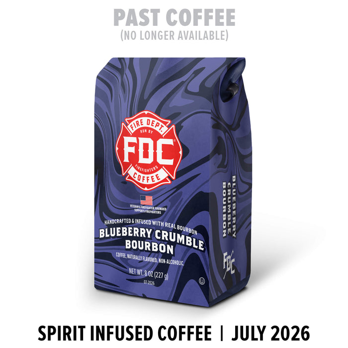 A bag of FDC Fire Department Coffee Blueberry Crumble Bourbon in a dark blue marbled pattern, with a red and white Fire Department logo. Text above says 'PAST COFFEE (NO LONGER AVAILABLE)' and text below says 'SPIRIT INFUSED COFFEE | JULY 2026'.