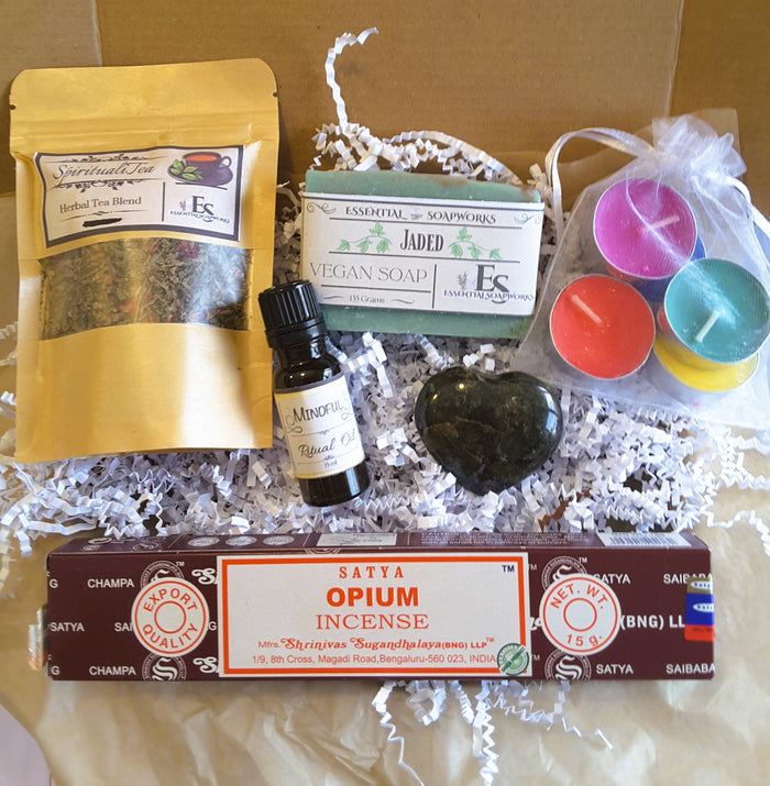Spiritual Self-Care Mystery Kit with tea, soap, candles, and incense on a white background