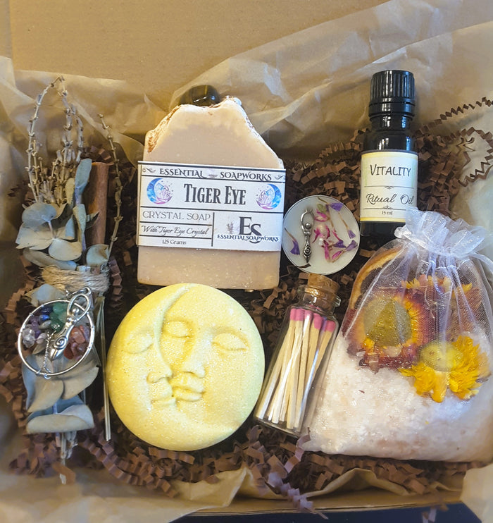 Tiger's Eye Crystal Ritual Kit with tiger's eye crystal soap, essential oil, and other wellness items on a wooden surface.