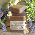 vanilla lavender tallow soap on a wooden surface with lavender flowers