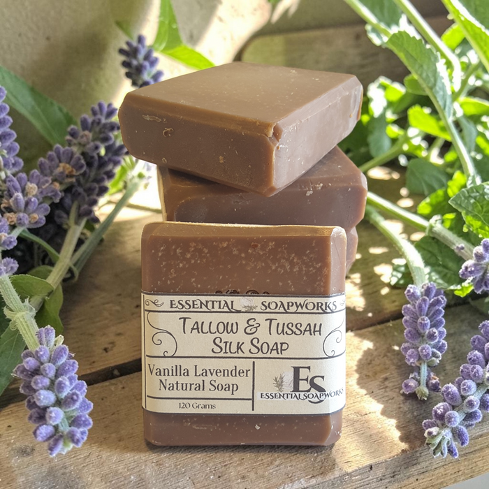 vanilla lavender tallow soap on a wooden surface with lavender flowers