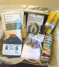Cozy witch self-care ritual kit with items like tea, tarot cards, and crystals.