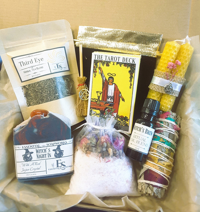 Cozy witch self-care ritual kit with items like tea, tarot cards, and crystals.