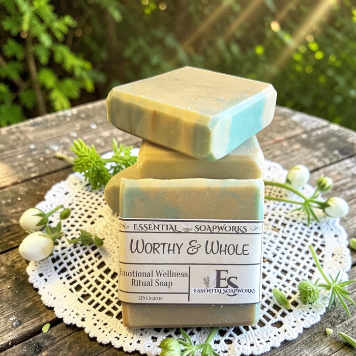 Worthy & Whole Emotional Wellness Soap on a wooden surface with decorative elements.