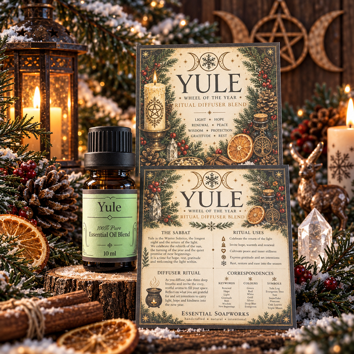 A Yule essential oil blend by Essential Soapworks, featuring a 10ml amber bottle with a black cap and a green label, alongside two decorative cards with detailed holiday rituals and illustrations, styled on a rustic wooden slice with pine branches, candles, and lanterns.